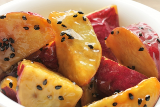 Japanese candied sweet potatoes, known as Daigaku Imo, glazed with a sweet syrup and sprinkled with black sesame seeds"